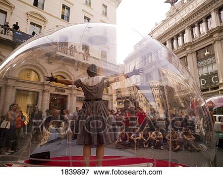 Woman Standing Inside Transparent Glass Globe And Crowd Watching Her Performance; Rome, Italy View Large Photo Image Stock Photo - Woman Standing Inside Transparent Glass Globe And Crowd Watching Her Performance; Rome, Italy. Fotosearch