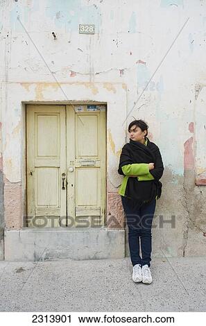Woman standing next to small, old doorway; San Luis de la Paz, Guanajuato, Mexico View Large Photo Image Stock Image - Woman standing next to small, old doorway; San Luis de la Paz, Guanajuato, Mexico. Fotosearch