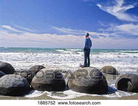 Woman Standing On One Of The Moeraki Boulders View Large Photo Image Stock Image - Woman Standing On One Of The Moeraki Boulders. Fotosearch