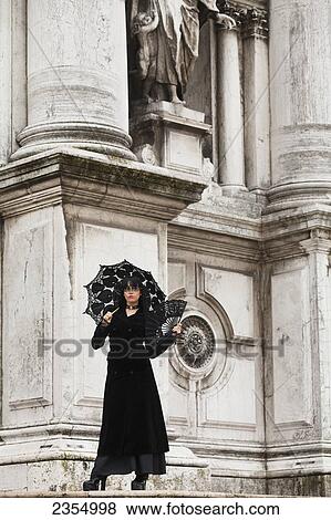 Stock Photo - Woman standing outside Santa Maria della Salute; Venice, Italy. Fotosearch