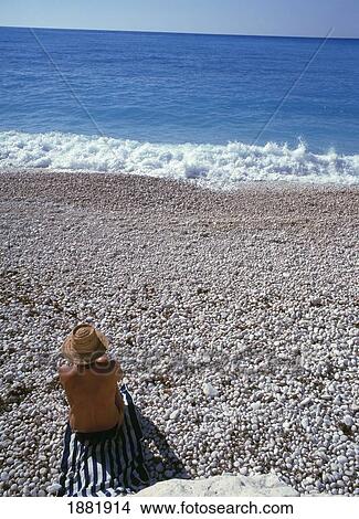 Picture - Woman Sun Tanning On Myrtos Beach. Fotosearch