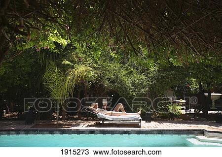 Woman Sunbathing By Swimming Pool View Large Photo Image Stock Image - Woman Sunbathing By Swimming Pool. Fotosearch