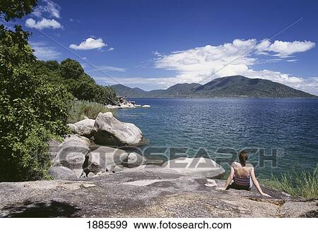 Woman Sunbathing Large Rocks On The Island Of Domwe View Large Photo Image Stock Photo - Woman Sunbathing Large Rocks On The Island Of Domwe. Fotosearch