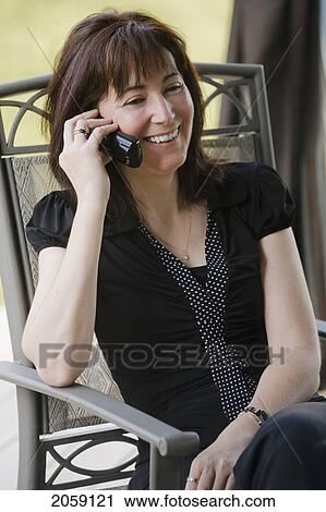 Stock Image - Woman Talking On A Cordless Phone. Fotosearch
