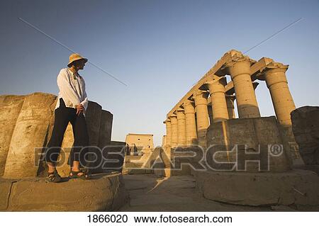 Stock Image - Woman Tourist At The Temple Of Luxor, Egypt. Fotosearch