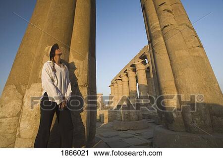 Stock Image - Woman Tourist At The Temple Of Luxor, Egypt. Fotosearch
