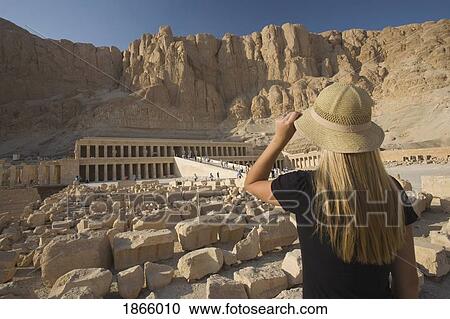 Stock Image - Woman Tourist Gazes At The Temple Of Hapshepsut; Nile Valley, Egypt, Africa. Fotosearch