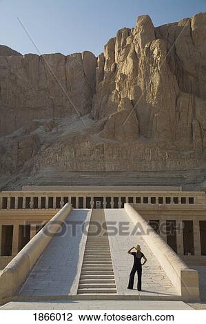 Woman Tourist Gazes At The Temple Of Hapshepsut; Nile Valley, Egypt, Africa View Large Photo Image Stock Image - Woman Tourist Gazes At The Temple Of Hapshepsut; Nile Valley, Egypt, Africa. Fotosearch