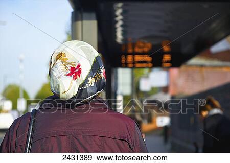 Woman waiting at a bus stop; London, England View Large Photo Image Stock Photo - Woman waiting at a bus stop; London, England. Fotosearch