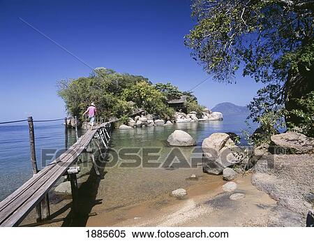 Stock Photography - Woman Walking Across Bridge To Small Island Off Mumbo Island. Fotosearch