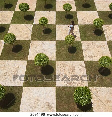 Stock Photograph - Woman Walking Across Manicured Courtyard, Dominican Republic.. Fotosearch
