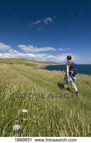 Woman Walking Along Coastal Path, Rear View View Large Photo Image Stock Image - Woman Walking Along Coastal Path, Rear View. Fotosearch
