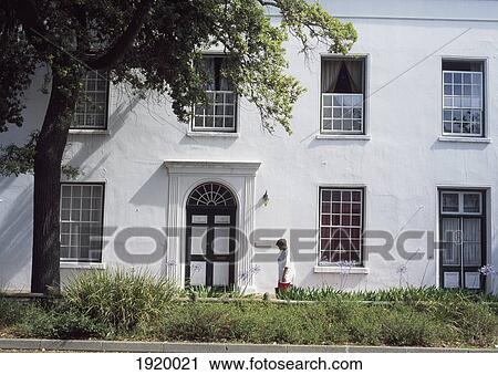 Woman Walking Along Colonial House View Large Photo Image Stock Image - Woman Walking Along Colonial House. Fotosearch