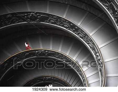 Stock Photo - Woman Walking Down Spiral Stairs In The Vatican Museum. Fotosearch