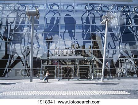 Stock Image - Woman Walking Into Selfridges. Fotosearch