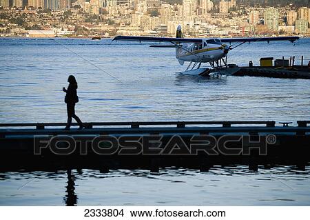 Picture - Woman Walking On Pier, Vancouver Waterfront, Harbor; Vancouver, British Columbia, Canada. Fotosearch
