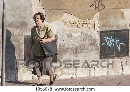Stock Photo - Woman Walking On The Street Of Sarajevo, Bosnia And Herzegovina. Fotosearch