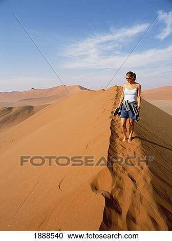 Woman Walking On Top Of Sand Dune In The Desert View Large Photo Image Stock Image - Woman Walking On Top Of Sand Dune In The Desert. Fotosearch