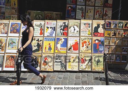 Stock Photo - Woman Walking Past Art Stalls In Montmartre, Paris, France, Europe (Model Release Available). Fotosearch