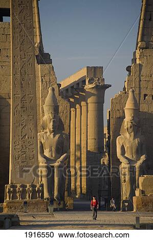 Stock Image - Woman Walking To Luxor Temple. Fotosearch