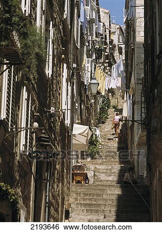 Woman Walking Up Steps In The Back Alleys Of Dubrovnik, Croatia. View Large Photo Image Stock Photograph - Woman Walking Up Steps In The Back Alleys Of Dubrovnik, Croatia.. Fotosearch