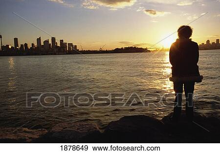 Stock Photo - Woman Watching Sunset In Sydney Harbor. Fotosearch