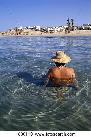 Woman Wearing A Sun Hat Wading In The Red Sea View Large Photo Image Stock Image - Woman Wearing A Sun Hat Wading In The Red Sea. Fotosearch
