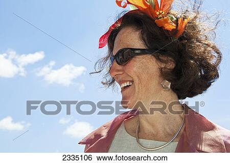 Stock Photograph - Woman Wearing Fascinator At Epsom Derby On Lady's Day; London, England, Uk. Fotosearch