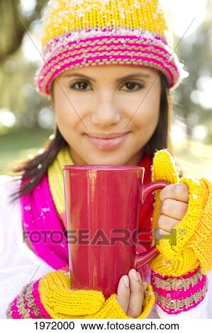 Woman Wearing Winter Clothing In Snowy Environment, Holding Hot Drink In Mug, Selective Focus On Mug. View Large Photo Image Stock Image - Woman Wearing Winter Clothing In Snowy Environment, Holding Hot Drink In Mug, Selective Focus On Mug.. Fotosearch