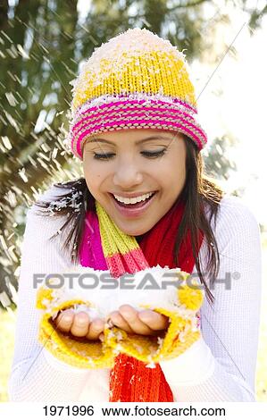 Woman Wearing Winter Clothing In Snowy Environment, Holding Snow In Hands. View Large Photo Image Stock Photograph - Woman Wearing Winter Clothing In Snowy Environment, Holding Snow In Hands.. Fotosearch
