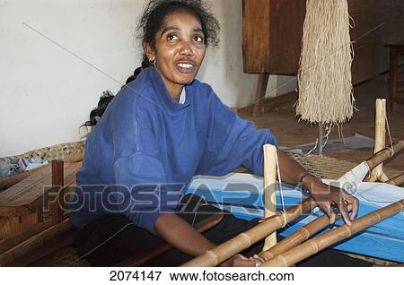 Stock Photo - Woman Weaving Silk At The Fabrique De Papier Antaimoro, Ambalavao, Fianarantsoa Province, Madagascar. Fotosearch