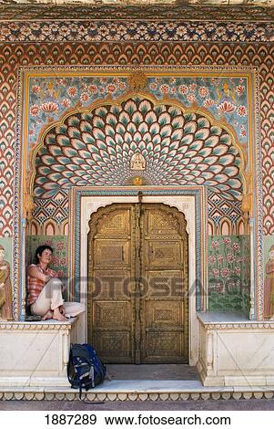 Stock Photo - Woman With Backpack Sitting In Decorated Entrance Area Of Door Of The City Palace. Fotosearch