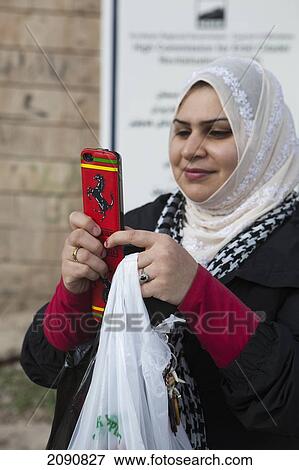 Stock Photo - Woman With Ferrari Cased Iphone, Erbil, Iraqi Kurdistan, Iraq. Fotosearch
