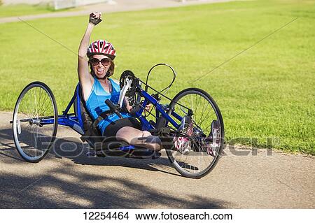 Picture - Woman with spinal cord injury using hand propelled bicycle; Edmonton, Alberta, Canada. Fotosearch