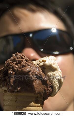 Stock Photography - Woman With Sunglasses Eating Ice Cream. Fotosearch