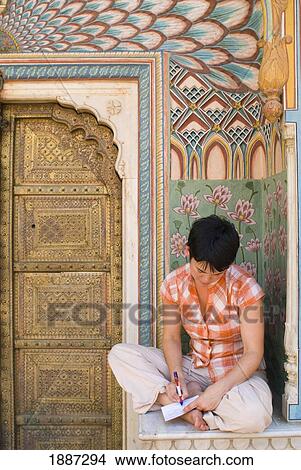 Picture - Woman Writing Postcard In Decorated Entrance Area Of The City Palace. Fotosearch