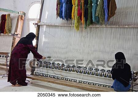 Stock Photography - Women At A Loom In A Carpet Factory, Saqqara, Al Jizah, Egypt. Fotosearch