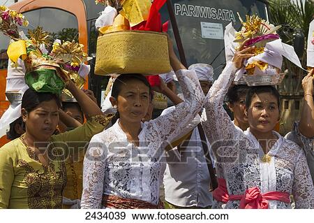 Stock Photo - Women carrying offerings at a ceremony, Baha, Bali, Indonesia. Fotosearch