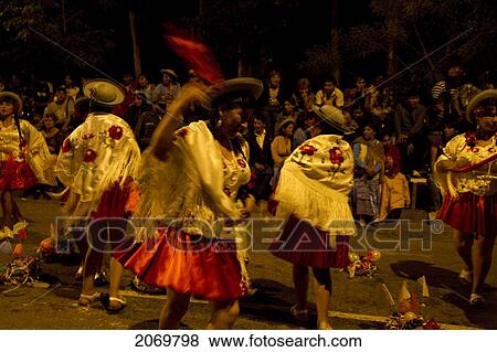 Stock Photo - Women Dancing Around Festive Baskets In The Gran Entrada De Comadres Parade During The Carnaval Chapaco At Night, Tarija, Bolivia. Fotosearch
