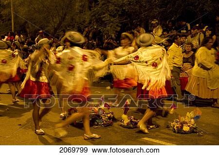 Stock Photo - Women Dancing Around Festive Baskets In The Gran Entrada De Comadres Parade During The Carnaval Chapaco At Night, Tarija, Bolivia. Fotosearch