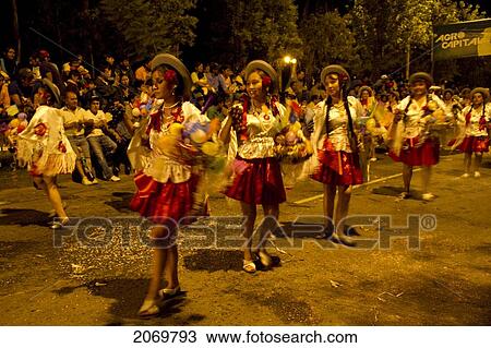 Stock Image - Women Dancing In The Gran Entrada De Comadres Parade During The Carnaval Chapaco At Night, Tarija, Bolivia. Fotosearch