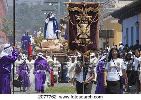 Stock Image - Women Dressed In Mourning Carry The Anda (Float) Of The Virgin Mary During The Procession Of The Holy Cross On Good Friday In Antigua Guatemala, Sacatep. Fotosearch