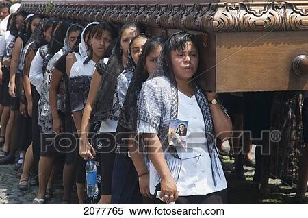 Stock Photography - Women Dressed In Mourning Carry The Anda (Float) Of The Virgin Mary During The Procession Of The Holy Cross On Good Friday In Antigua Guatemala, Sacatep. Fotosearch