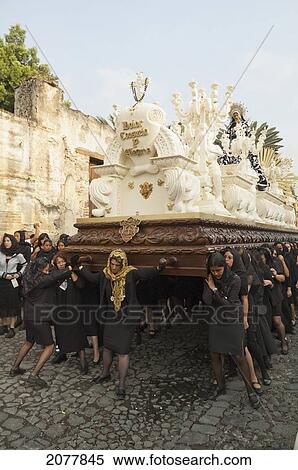 Stock Photography - Women Dressed In Mourning Carry The Anda (Float) Of The Sorrowful Virgin Mary During The Holy Burial Procession On Good Friday In Antigua Guatemala, Sacatep. Fotosearch