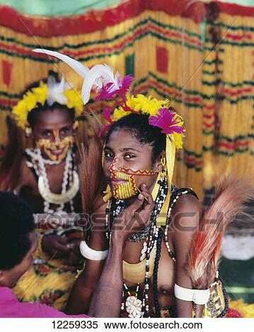 Stock Photography - Women from Mekeo village preparing for a cultural performance; Central Province, Papua New Guinea. Fotosearch
