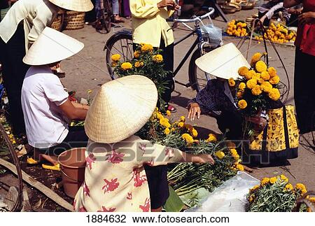 Stock Image - Women In Conical Hats In Ho Chi Minh City Market. Fotosearch