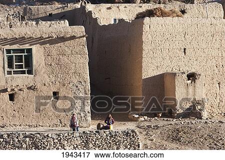 Stock Photo - Women In Front Of Their Mud Houses In Shibar, Bamian Province, Afghanistan. Fotosearch