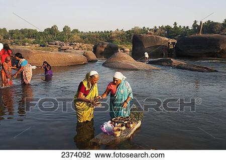 Women in the river in a religious ceremony; Hampi, Karnataka, India View Large Photo Image Stock Image - Women in the river in a religious ceremony; Hampi, Karnataka, India. Fotosearch