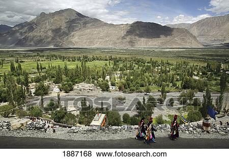 Women In Traditional Dress Walking Along Road At Base Of Mountains View Large Photo Image Stock Photo - Women In Traditional Dress Walking Along Road At Base Of Mountains. Fotosearch