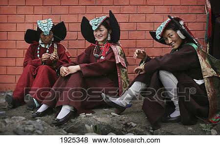 Stock Photo - Women In Traditional Headwear Sitting By Brock Wall, Diskyid, Nubra Valley, Leh Ladakh, India. Fotosearch